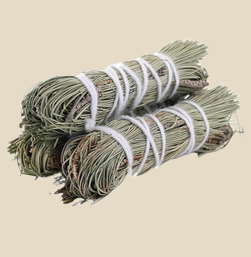 Pine Smudge Stick with pine needles tied with twine.