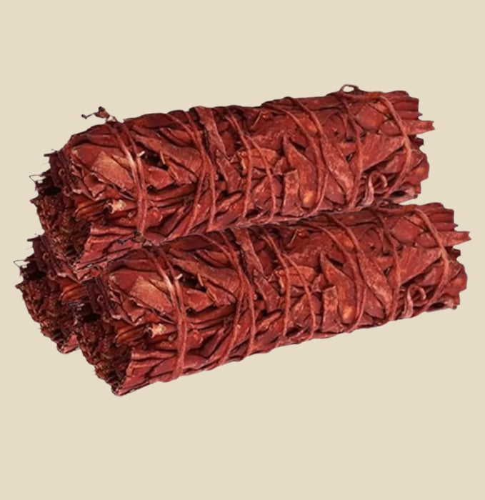 bundle of dried sage herbs infused with Dragon's Blood resin, tightly wrapped with natural string.