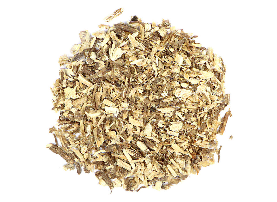 Organic Angelica Root, dried herb pieces, on a white background, used for healing and cooking.