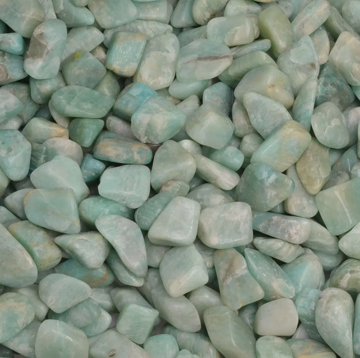 A close-up of tumbled amazonite with a deep green hue.