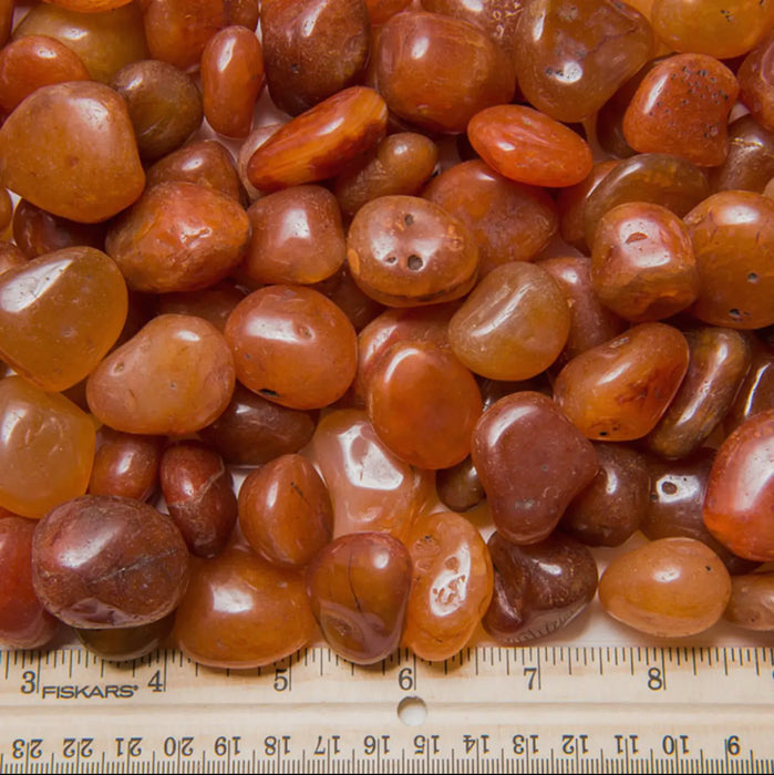 Smooth, tumbled carnelian with a vibrant orange color