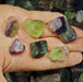 A large, raw rainbow fluorite crystal with a rough texture