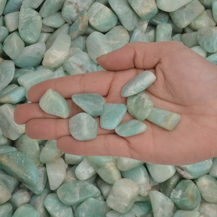 Tumbled amazonite in a crystal grid with other healing stones