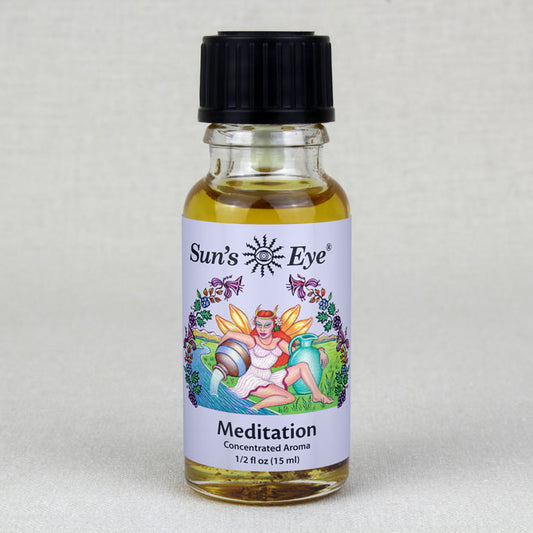A person sitting in a lotus position while holding a bottle of Meditation Oil