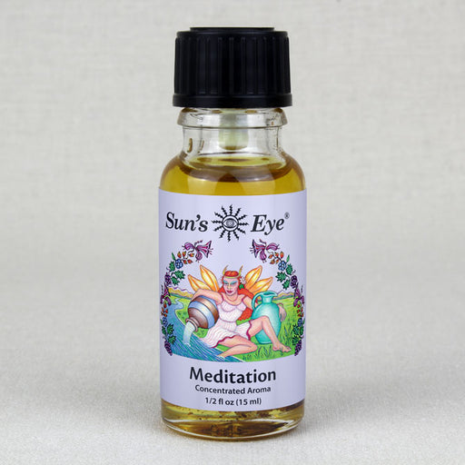 A person sitting in a lotus position while holding a bottle of Meditation Oil